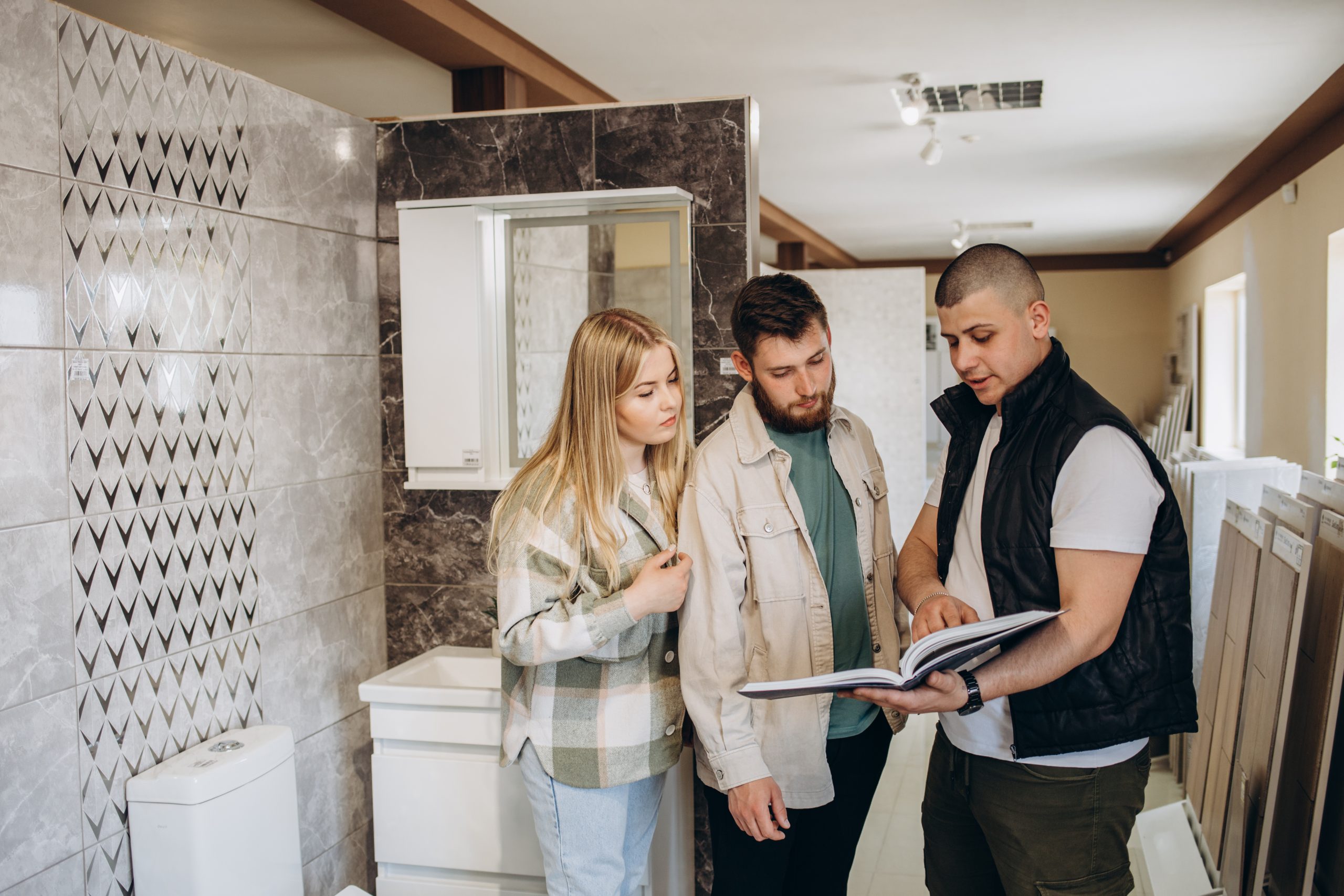 couple-looking-tiled-bathroom-they-are-in-a-wareh-2023-05-30-22-09-59-utc-scaled