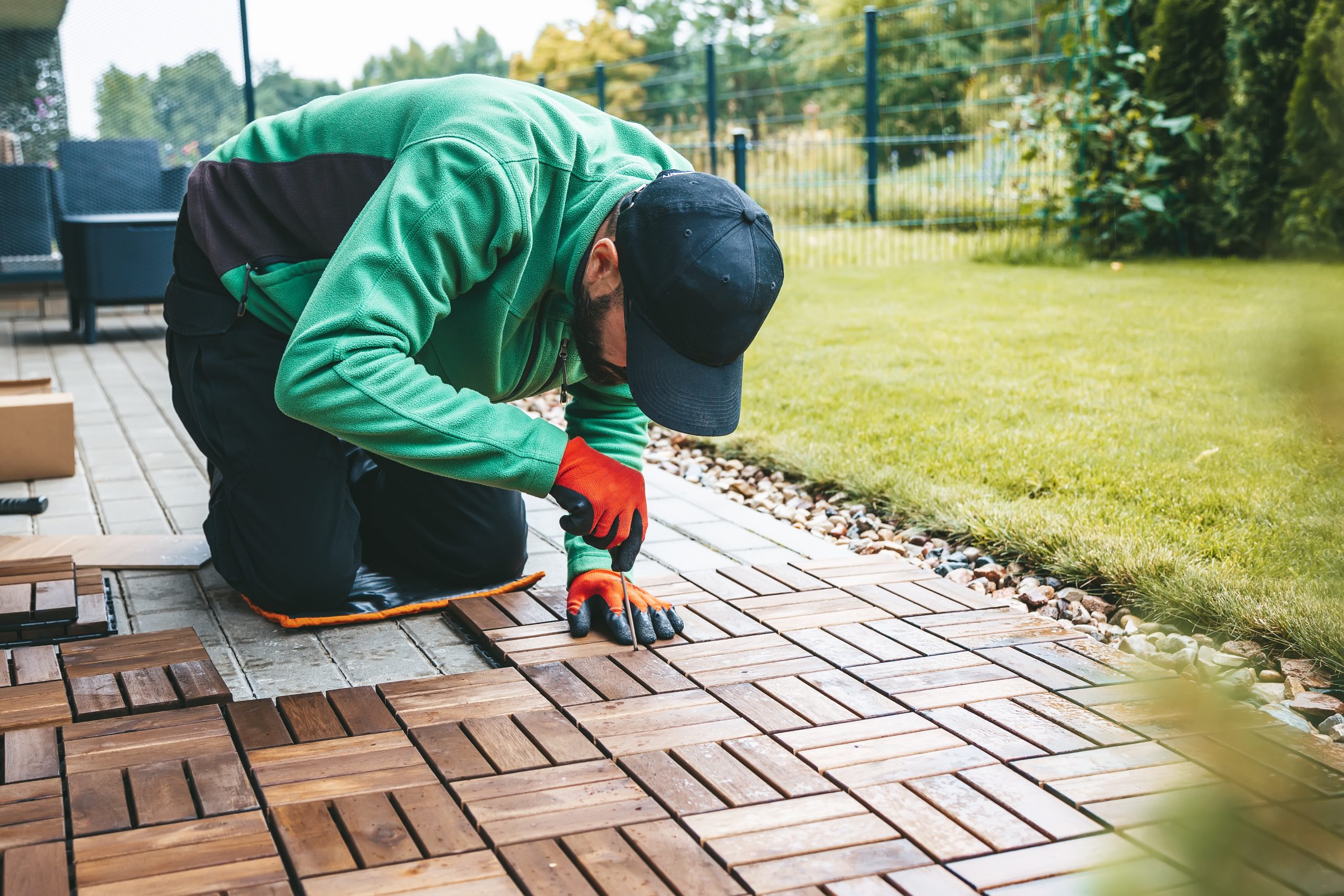 woodworking-on-the-terrace-a-man-laying-the-floor-2023-11-27-05-22-49-utc-scaled